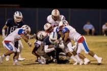 Centennial Bulldogs receiver Savon Scarver (11) is wrapped up by a collection of Liberty Pat ...