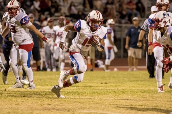Liberty Patriots runningback Stephon Stowers (15) runs with the ball against the Centennial ...