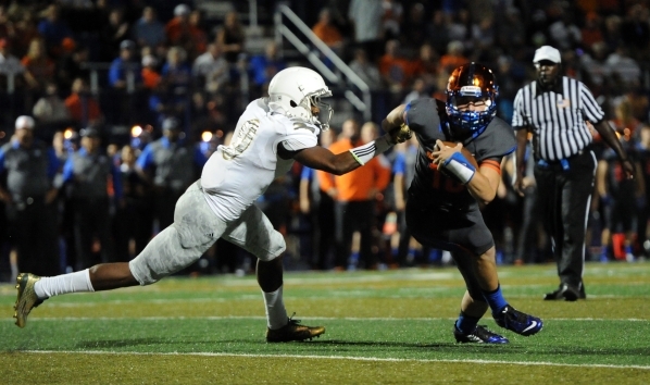 Bishop Gorman quarterback Tate Martell (18) eludes Long Beach Poly Jackrabbits defensive bac ...