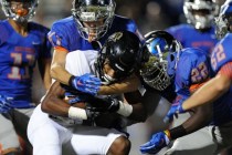 Bishop Gorman linebacker Brock Ruggeroil (41) and Bishop Gorman linebacker Ikem Okeke (22) t ...