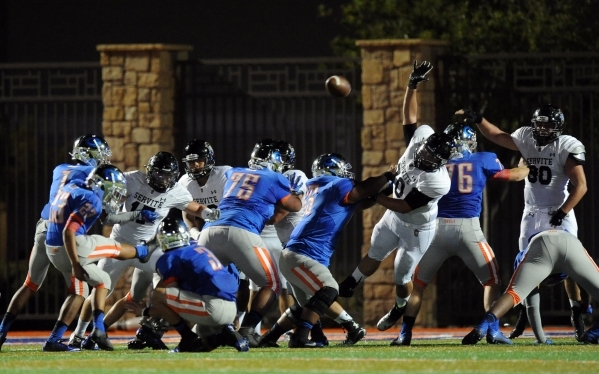 Bishop Gorman kicker Derek Ng (23) kicks a field goal while Servite Friars defensive end Joh ...