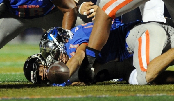 Servite running back Steven Muise watches the ball bounce away after he fumbled the football ...