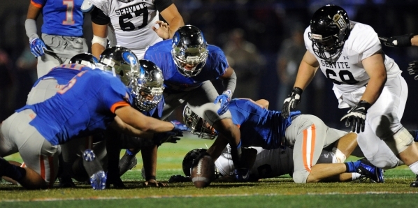 Bishop Gorman defensive end Blake Forte, left, and the rest of the Gorman defense cover up a ...