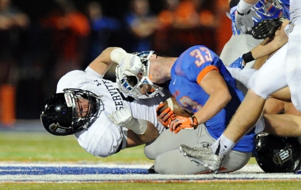 Servite Friars linebacker Connor Airey (5) rips the helmet off of Bishop Gorman running back ...