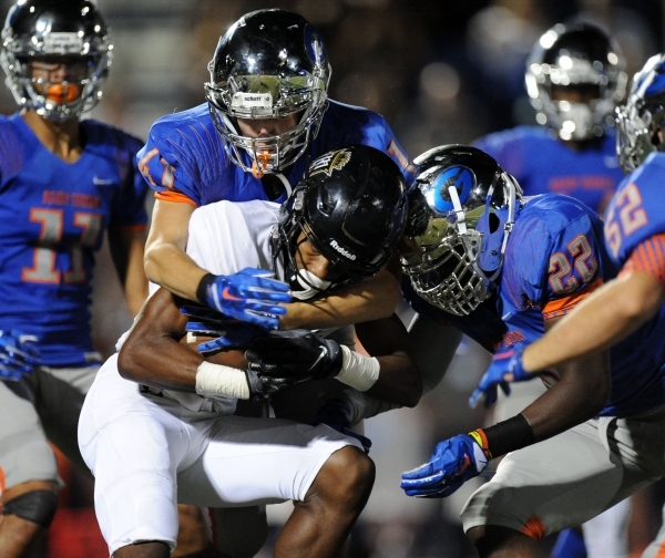 Bishop Gorman linebacker Brock Ruggeroil (41) and Bishop Gorman linebacker Ikem Okeke (22) t ...