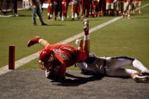 Arbor View High School running back Deago Stubbs dives over a Basic High School player for a ...
