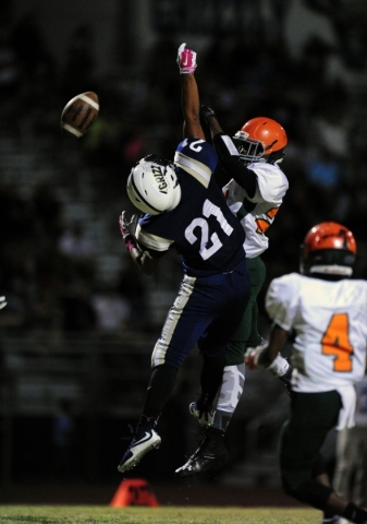 Mojave Rattlers safety Jesse James, right, breaks up a pass intended for Spring Valley Grizz ...