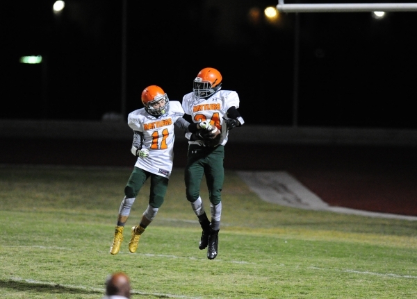 Mojave wide receivers Jaylon Delgado (11) and Jesse James celebrate a touchdown against Spri ...
