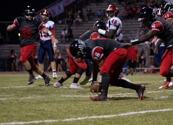 Las Vegas&lsquo; Josh Perez (26) picks up a Coronado fumble during their prep football game ...