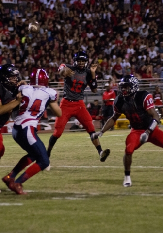Las Vegas High School quarterback Zach Matlock (12) passes the ball for a touchdown during t ...