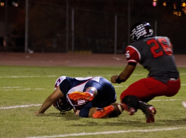 Coronado&lsquo;s Adolfo Sandoval (77) attempts to recover a high snap as Las Vegas&lsquo; Jo ...