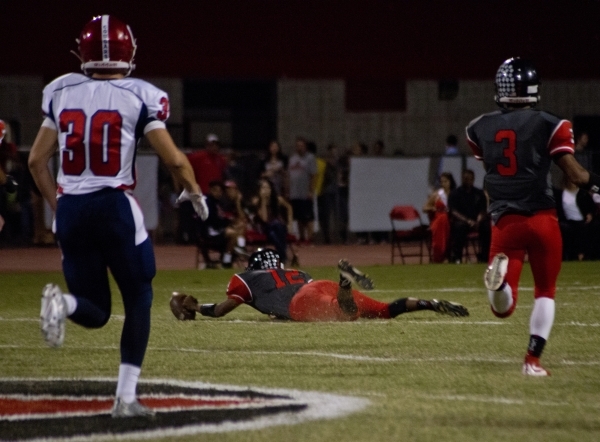 Las Vegas High School quarterback Zach Matlock (12) recovers a fumbled snap during their pre ...