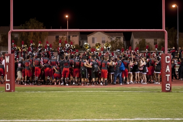 The Las Vegas High School football team celebrates their win after their prep football game ...