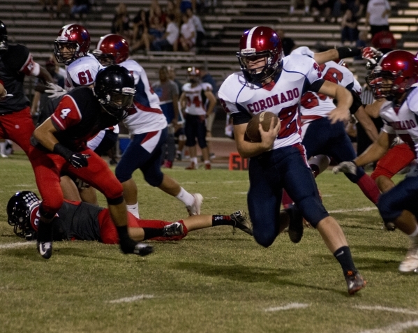 Coronado&lsquo;s Walker Wright (32) attempts to move the ball upfield during their prep foot ...
