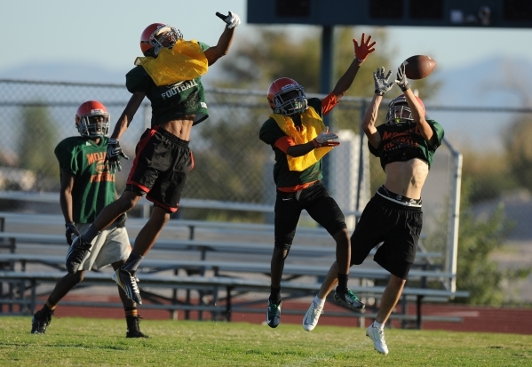 Mojave Rattlers wide receiver Jaylon Delgado, far right, is unable to make a catch while bei ...