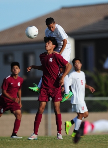 Arbor View defender Tyler Authement jumps onto the shoulders of Cimarron-Memorial forward Ar ...