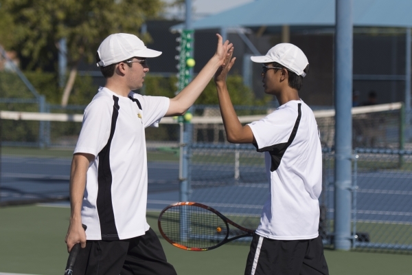 Derek Stratton, left, and Justin Ong of Ed W. Clark High School high five while playing agai ...