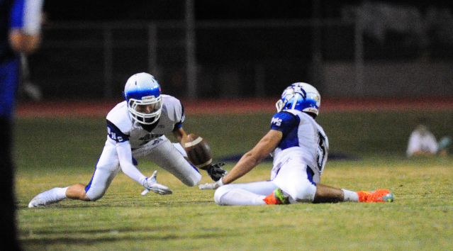 Basic Wolves safety Austin Owens, left, recovers a Green Valley fumble in the first quarter ...