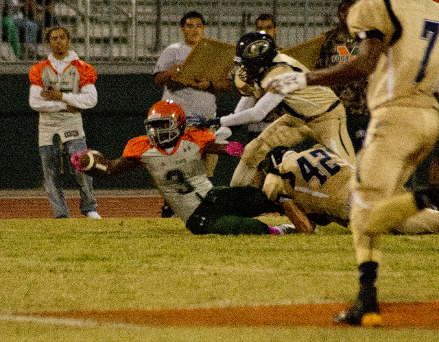 Mojave&lsquo;s Elijah Smoot (3) extends the ball for more yardage at the end of a run during ...