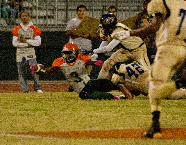 Mojave‘s Elijah Smoot (3) extends the ball for more yardage at the end of a run during ...