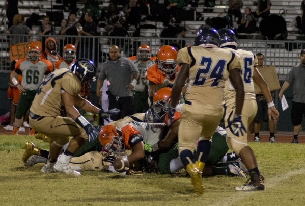 Cheyenne and Mojave players scramble to recover a fumble during their prep football game at ...