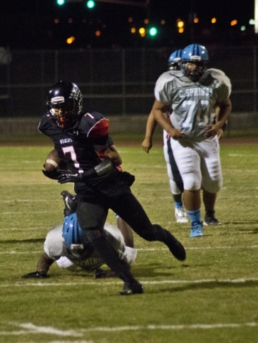 Las Vegas‘ Raul Perez (7) runs the ball up the field during their prep football game a ...