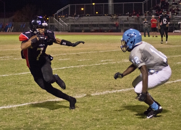 Canyon Springs‘ Jaleel Rogers (23) breaks a tackle during their prep football game at ...