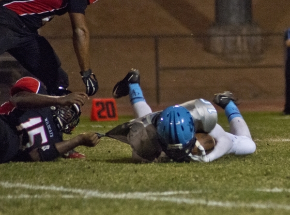 Canyon Springs‘ Diamante Burton (10) is tackled by Thomas Dorsey (15) during their pre ...