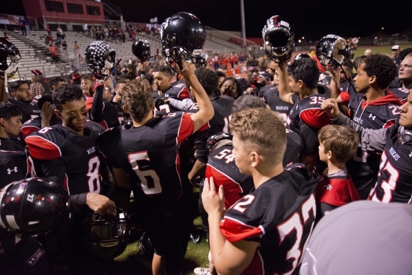 The Las Vegas High School football team celebrates a win after their prep football game agai ...