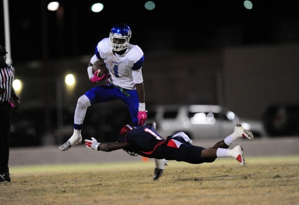 Green Valley Gators wide receiver Marquez Powell (1) breaks the tackle of Coronado Cougars d ...