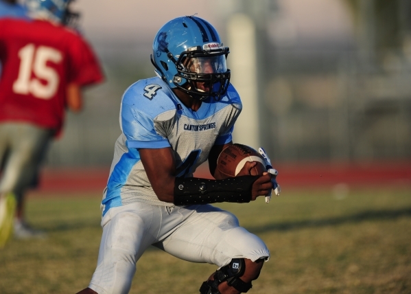 Canyon Springs running back Marcell Selmon rushes the ball during football practice at Canyo ...