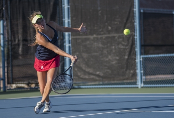Payton Burk from Liberty High School plays in a doubles match with her twin sister Parker du ...