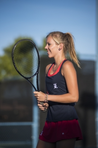 Parker Burk from Liberty High School plays in a doubles match with her twin sister Payton du ...