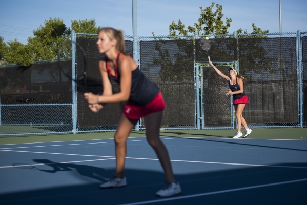 Twin sisters from right, Payton and Parker Burk from Liberty High School plays during their ...