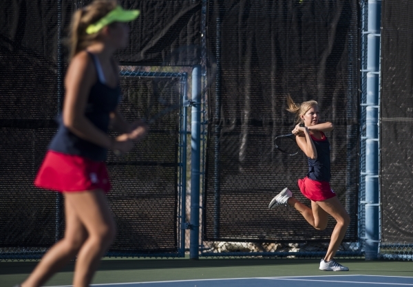 Twin sisters from right, Parker and Payton Burk from Liberty High School plays during their ...