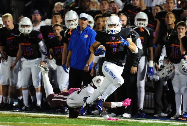 Bishop Gorman running back Biaggio Ali Walsh (7) runs past Don Bosco safety wide receiver Ha ...