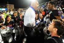 Bishop Gorman head coach Kenny Sanchez and players celebrate their 30-16 win over Don Bosco ...
