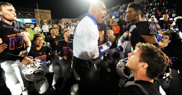 Bishop Gorman head coach Kenny Sanchez and players celebrate their 30-16 win over Don Bosco ...