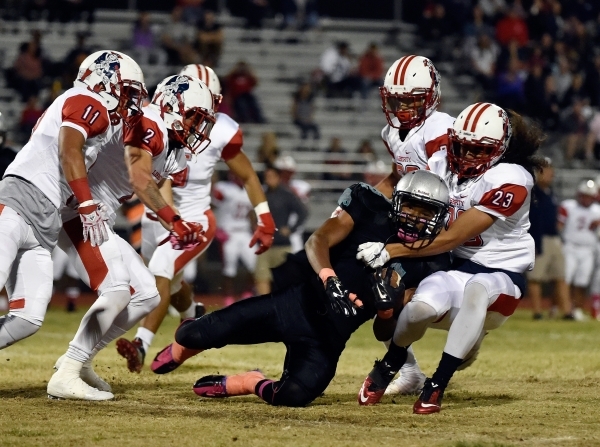 Silverado‘s Devion Clayton is brought down by Liberty‘s defense during the first ...