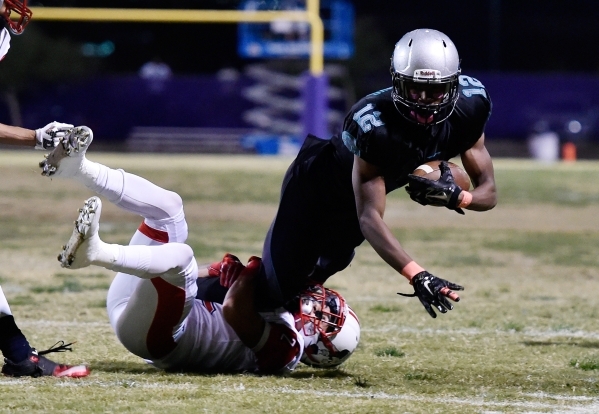 Silverado‘s Devion Clayton (12) dives for extra yardage as Liberty‘s Ethan Dedea ...