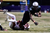 Silverado‘s Devion Clayton (12) dives for extra yardage as Liberty‘s Ethan Dedea ...