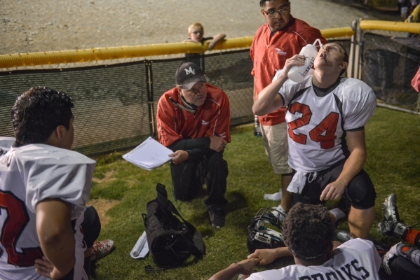 Mountain View Christian High School head football coach Ray LeBeouf, center, draws up plays ...