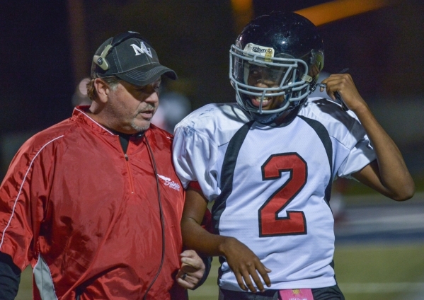 Mountain View Christian High School head football coach Ray LeBeouf talks with player Tyrell ...