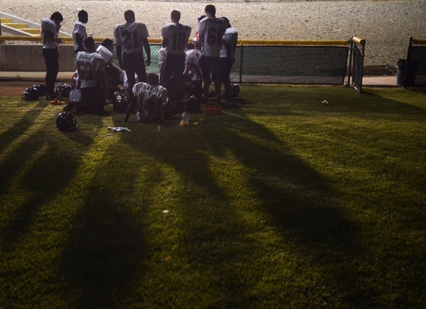 Mountain View Christian High School football players meet on the baseball field behind the f ...