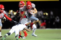 Arbor View running back defensive back Deago Stubbs jumps over Centennial cornerback Demetri ...