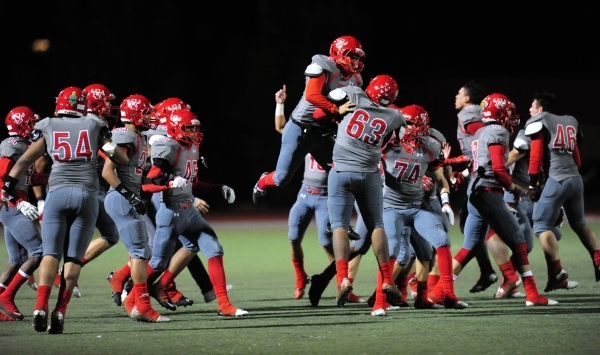 Arbor View players celebrate their 17-14 victory over Centennial as time expires in the four ...