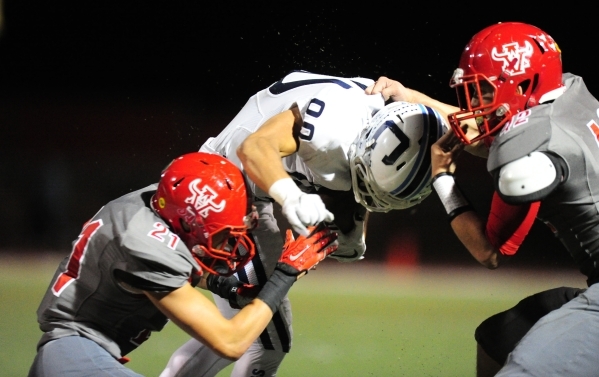 Arbor View defensive back Alex Sims (21) and Arbor View linebacker Andrew Wagner (42) tackle ...
