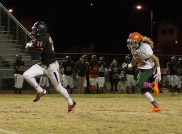 Chaparral‘s Casey Acosta (21) runs the ball against Mojave High School‘s defense ...