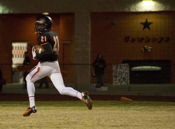 Chaparral‘s Casey Acosta (21) looks behind him as he runs toward the end zone in the f ...