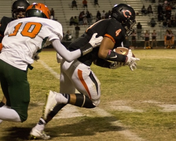 Chaparral‘s Richard Hernandez (4) intercepts a pass and is tackled by Mojave‘s A ...